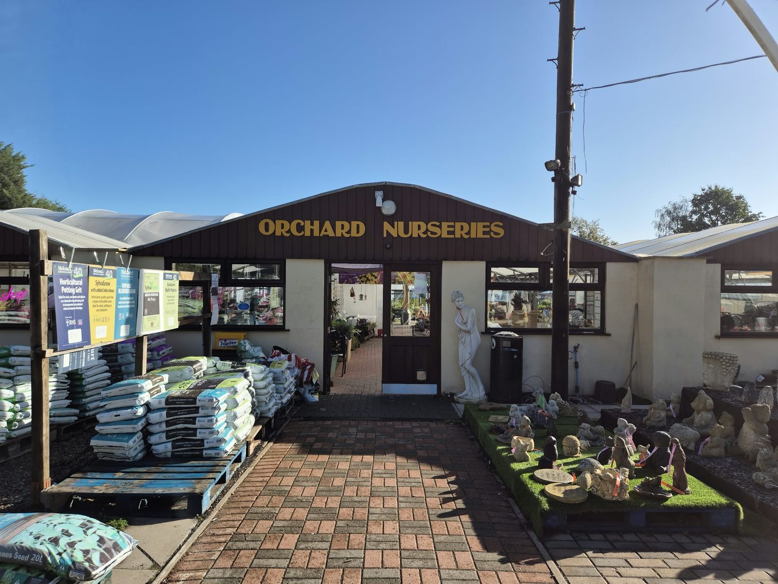 The Orchard Nurseries entrance on Birmingham Road, Water Orton, with plants and ornaments outside