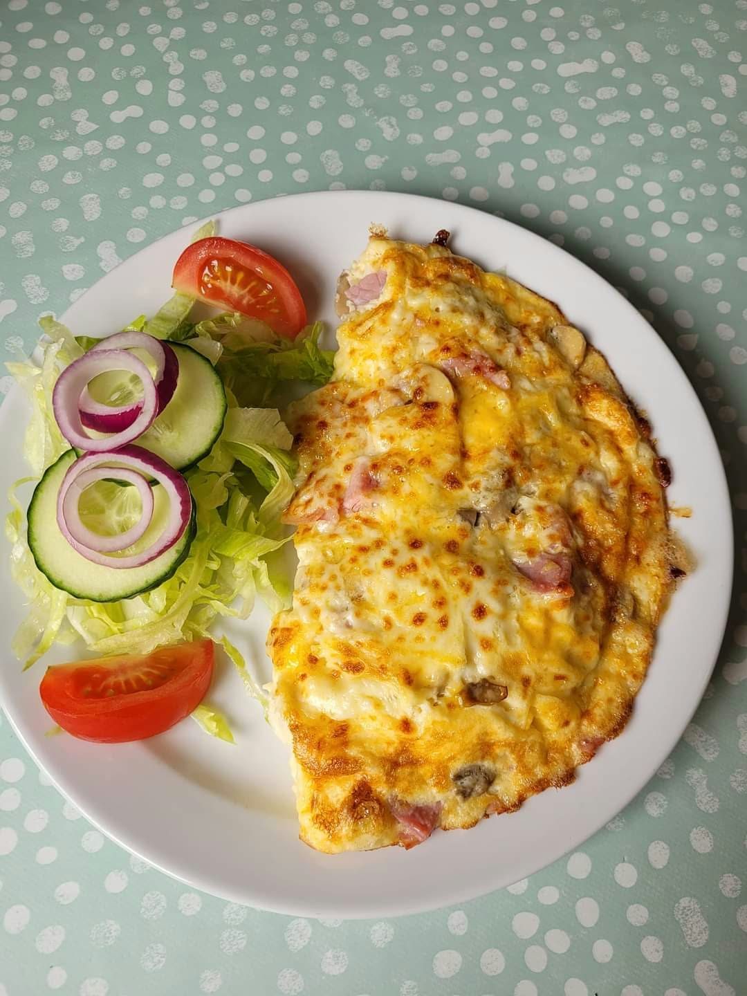 Freshly cooked omelette with salad