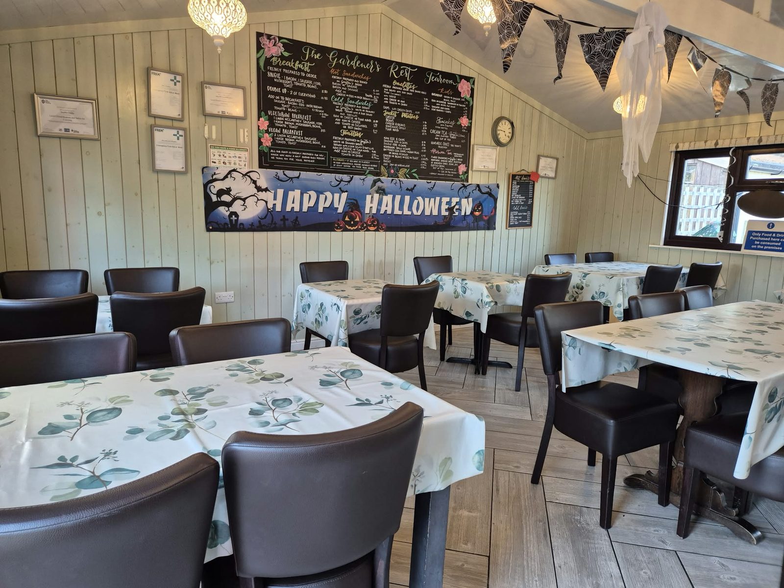 Tables laid with fresh cloths inside the Gardeners Rest Tearooms
